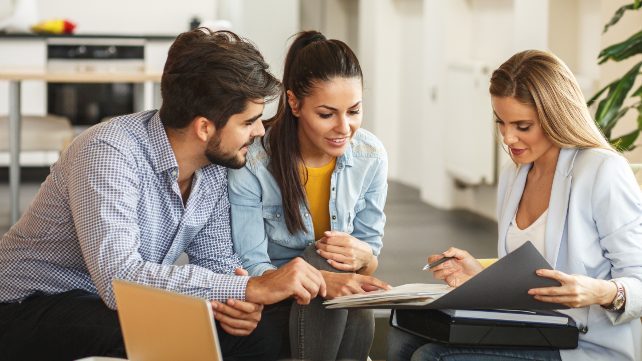 couple reviewing documents with agent