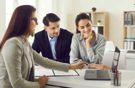 couple looking at laptop with agent