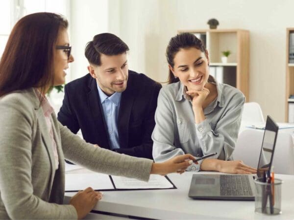 couple looking at laptop with agent