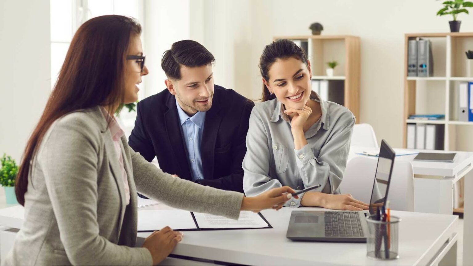 couple looking at laptop with agent
