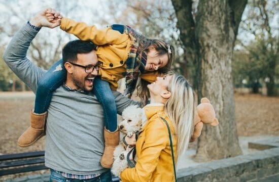 family girl on dad's shoulders