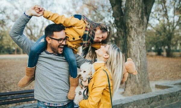 family girl on dad's shoulders