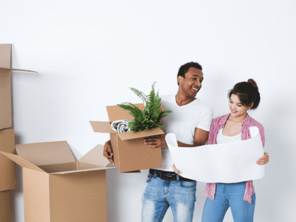 couple with boxes reviewing floor plans