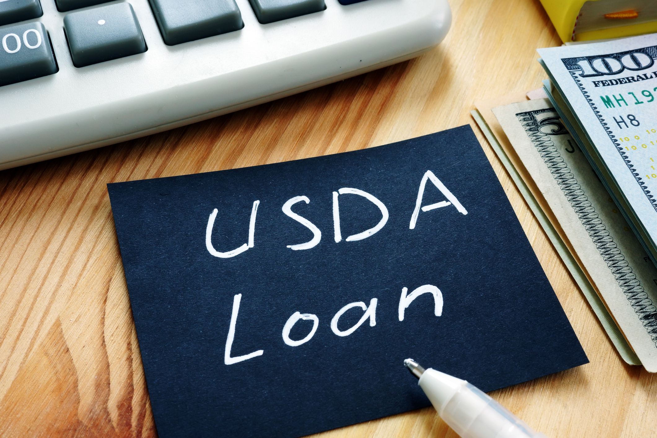 Piece of paper sitting on table. USDA Loan written on paper.